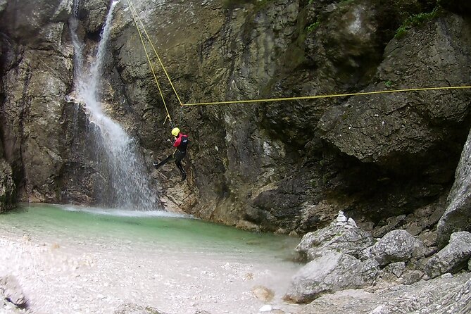 Canyoning In The Triglav National Park - The 50-meter descent beside Parabola waterfall