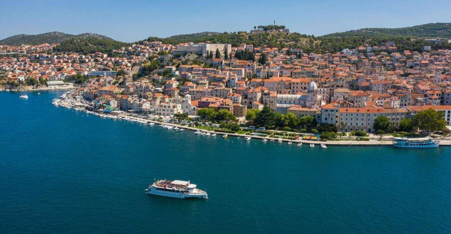 Vodice: Krka Waterfalls National Park Boat Tour - Collecting mussels from a local farm